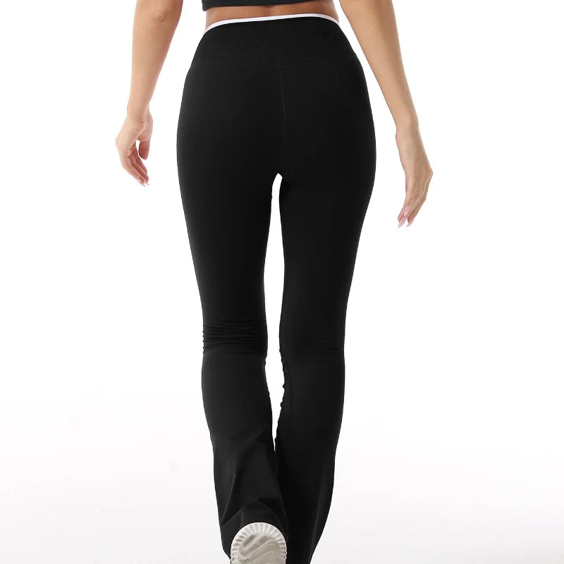 Sculvea push-up flare leggings - black - back view, walking